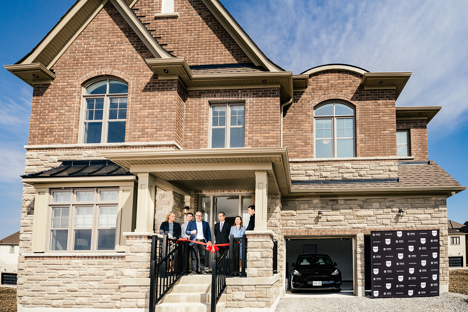 ribbon cutting in front of Net Zero home