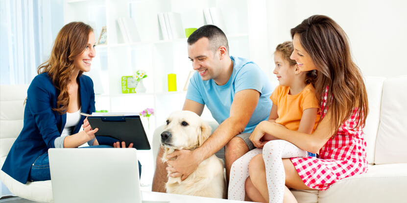 family with dog talking to mortgage broker