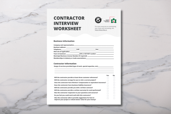 A contractor interview worksheet on a marble surface, featuring sections for business and contractor information, and a checklist of questions for evaluating the contractors services and qualifications.